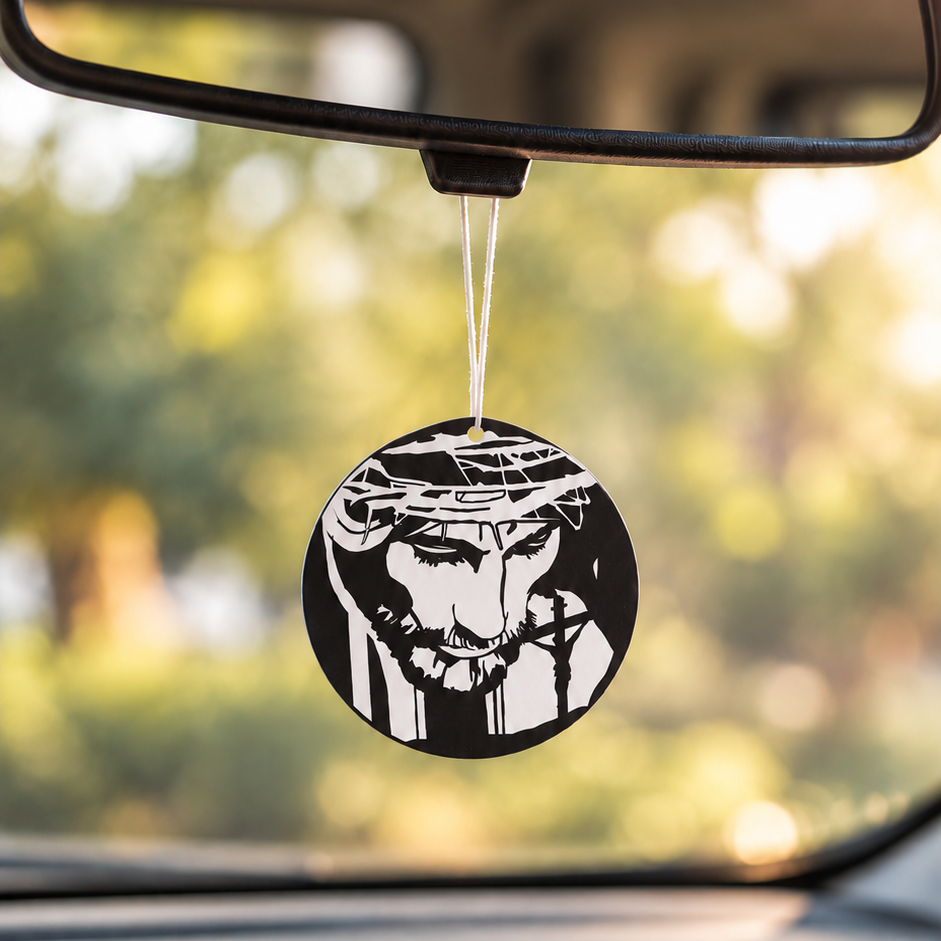 Jesus Crown of Thorns car air freshener hanging from a rear-view mirror