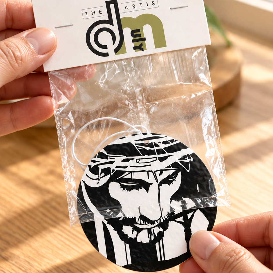 Jesus Crown of Thorns car air freshener being removed from DMuly retail packaging