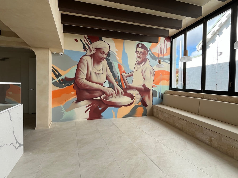 Commercial interior mural by DMuly showing two people preparing food against an abstract pastel background