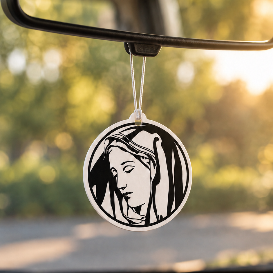 Mother Mary car air freshener hanging from a rear-view mirror